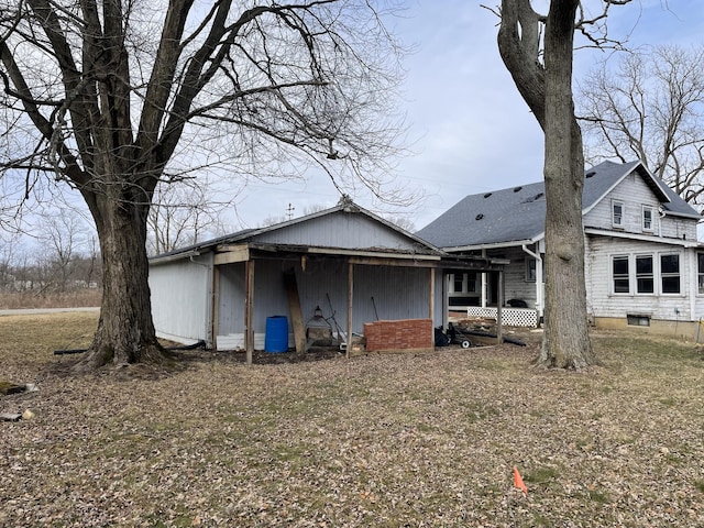 back of property featuring a shingled roof