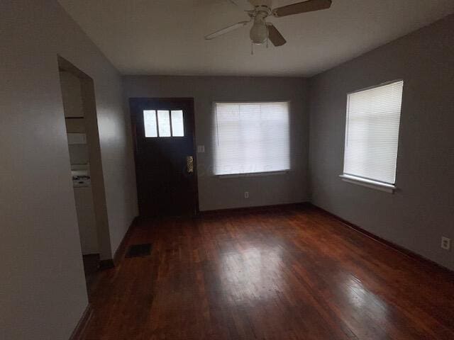 entrance foyer with baseboards, visible vents, a ceiling fan, and wood finished floors