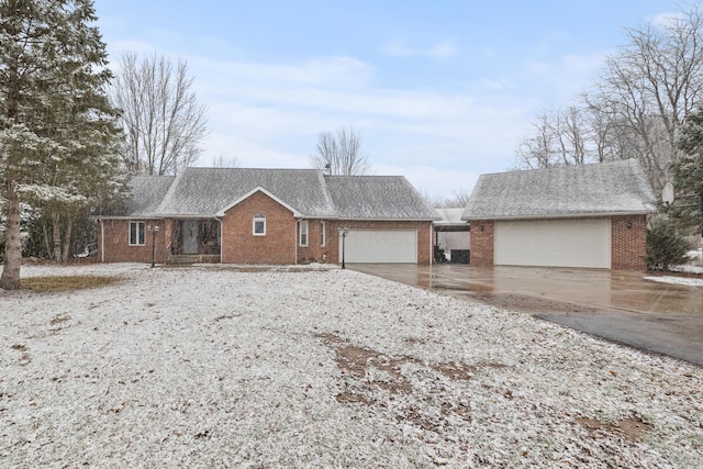 single story home with a garage, brick siding, and roof with shingles