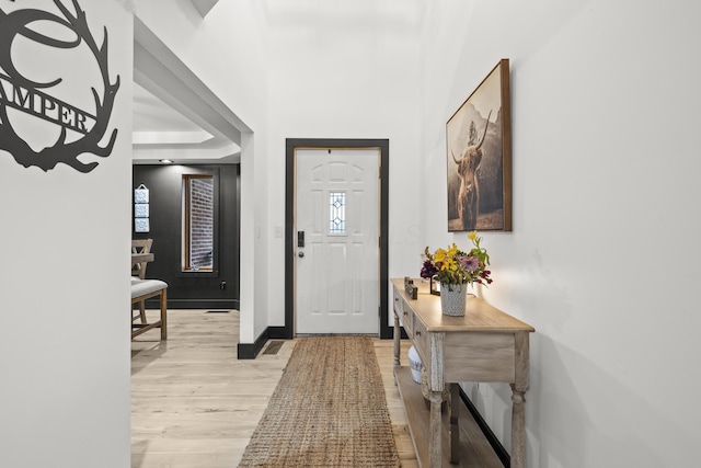 entrance foyer featuring light wood-style flooring and baseboards