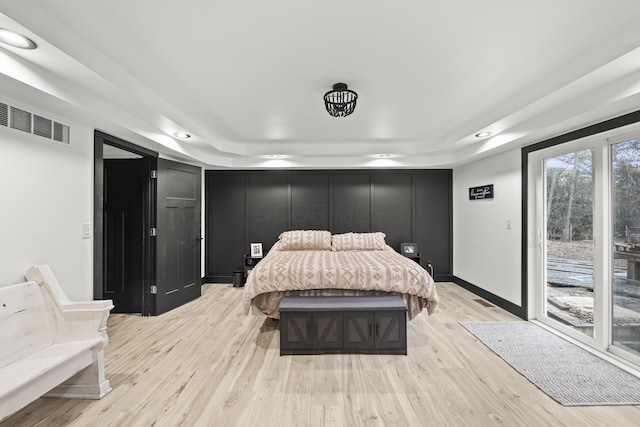 bedroom with access to outside, baseboards, visible vents, and light wood-type flooring