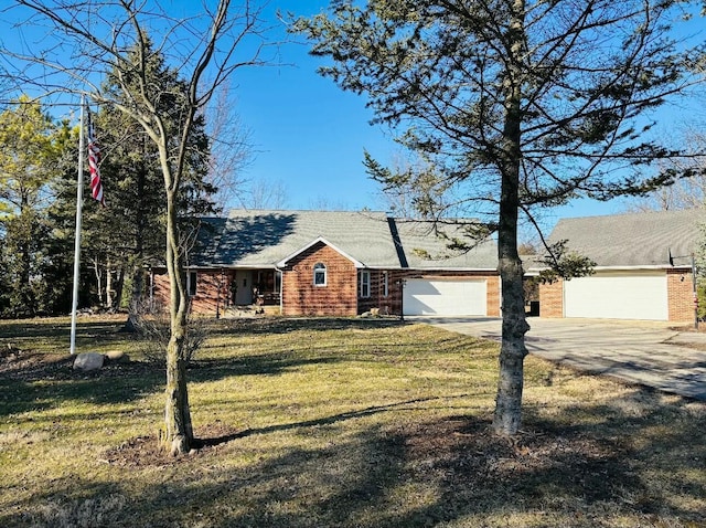 ranch-style home with an attached garage, concrete driveway, and a front yard