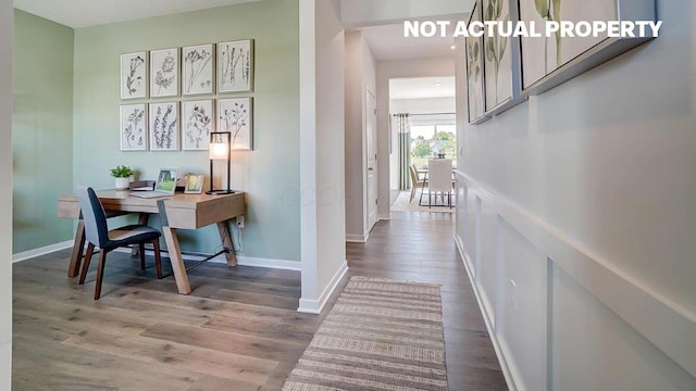 hall featuring wood finished floors and baseboards