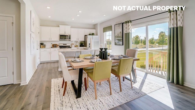 dining room featuring recessed lighting, light wood-style floors, and baseboards