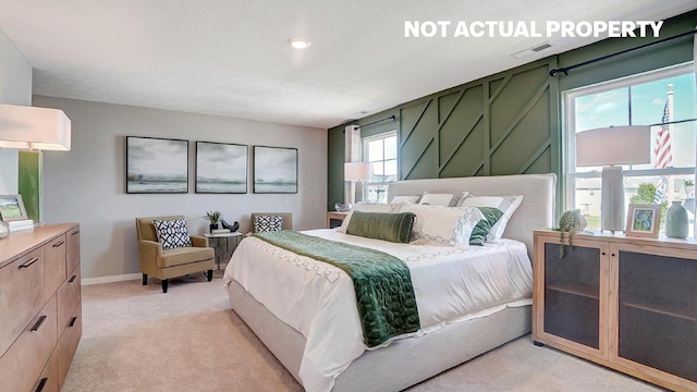 bedroom with visible vents, baseboards, and light colored carpet