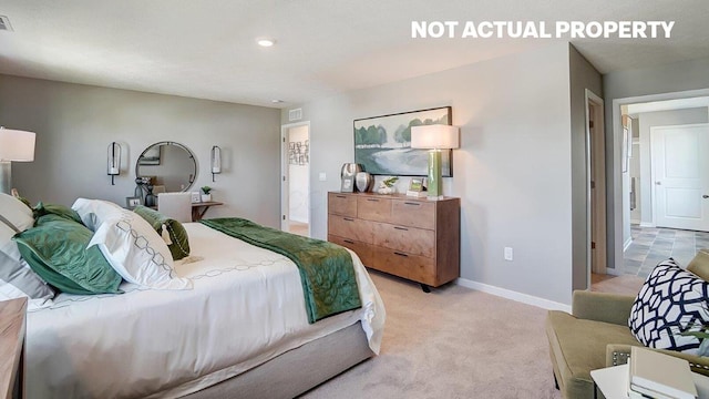 bedroom featuring visible vents, light colored carpet, and baseboards