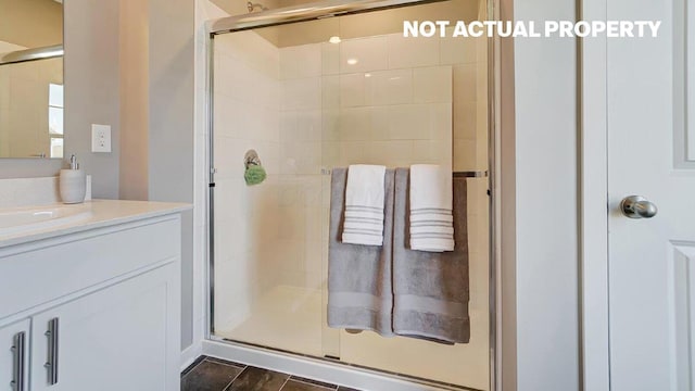 full bath featuring vanity and a stall shower