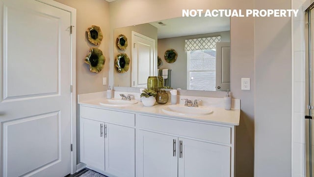 bathroom featuring a sink, visible vents, and double vanity