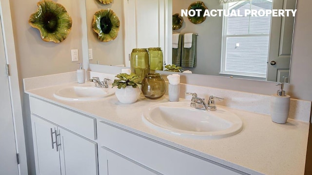 full bathroom with double vanity and a sink