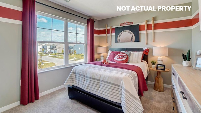 bedroom with baseboards and carpet flooring