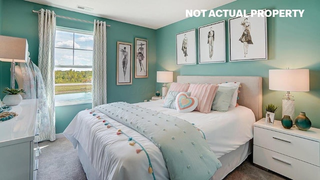 bedroom with visible vents and carpet flooring