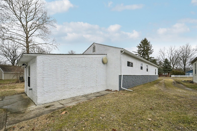 view of home's exterior with a yard and stucco siding