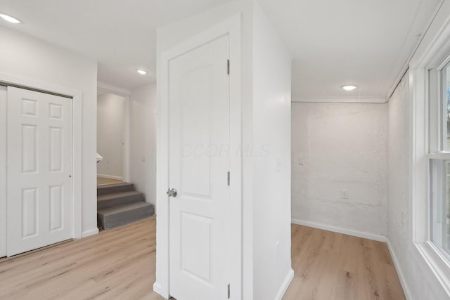 hall with stairs, light wood finished floors, baseboards, and recessed lighting