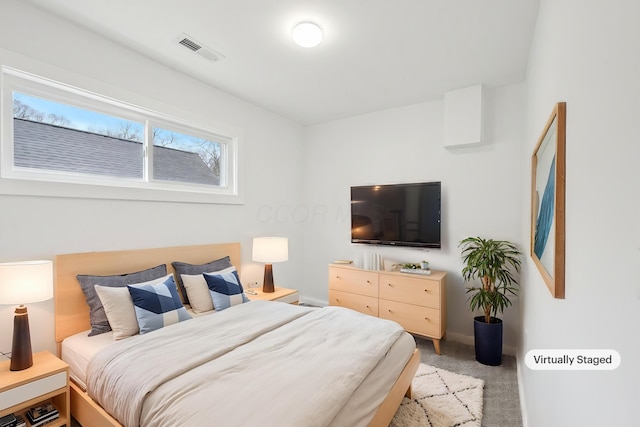 bedroom with carpet, visible vents, and baseboards