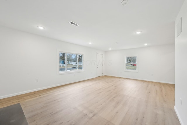 empty room with recessed lighting, visible vents, a healthy amount of sunlight, and light wood finished floors
