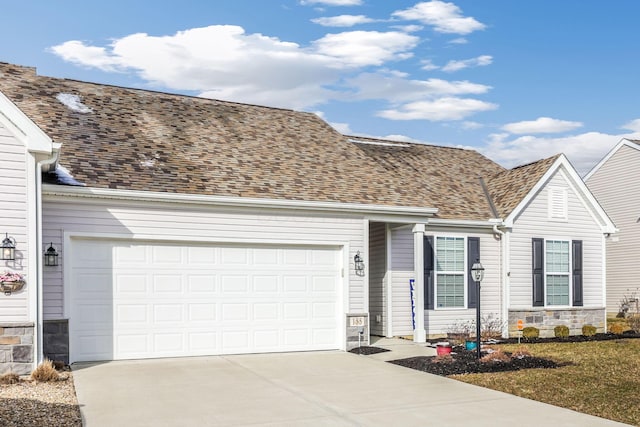 view of front of home featuring a garage, stone siding, driveway, and a shingled roof