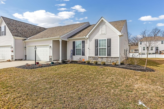 view of front of home with stone siding, concrete driveway, a front yard, and roof with shingles