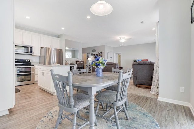 dining room featuring light wood-style flooring, recessed lighting, baseboards, and ceiling fan