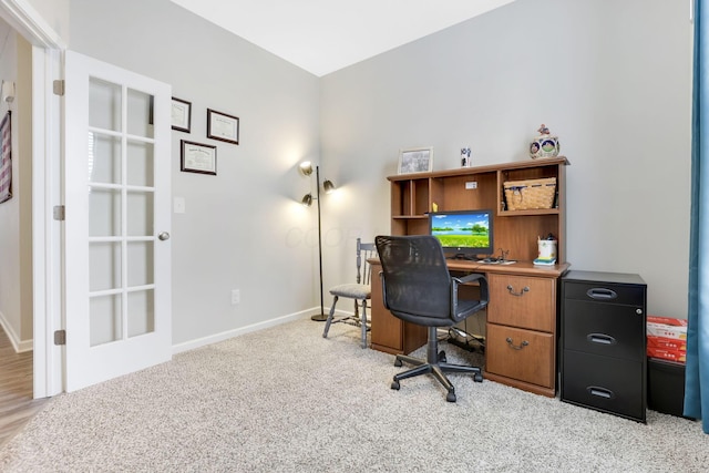 office area featuring baseboards and light colored carpet