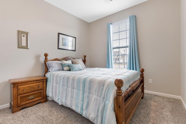 bedroom with visible vents, light colored carpet, and baseboards