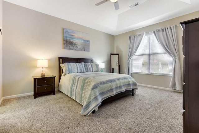 carpeted bedroom featuring a ceiling fan, baseboards, and visible vents