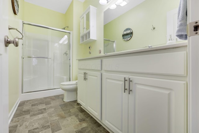 full bathroom featuring stone finish floor, a stall shower, and toilet