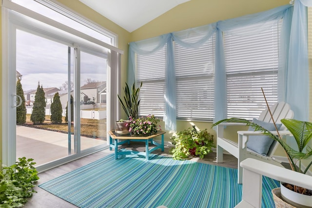 sunroom featuring vaulted ceiling