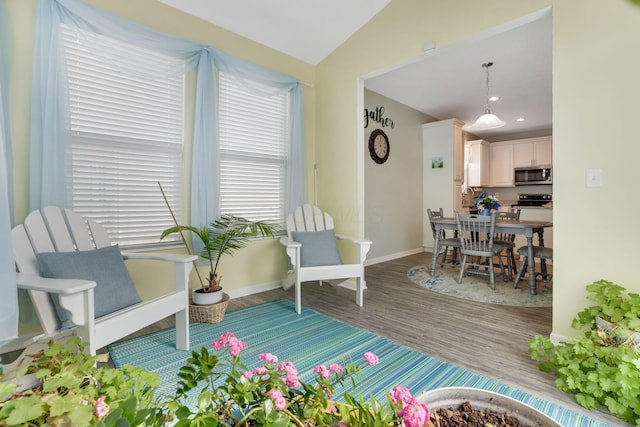 sitting room featuring vaulted ceiling, recessed lighting, baseboards, and wood finished floors