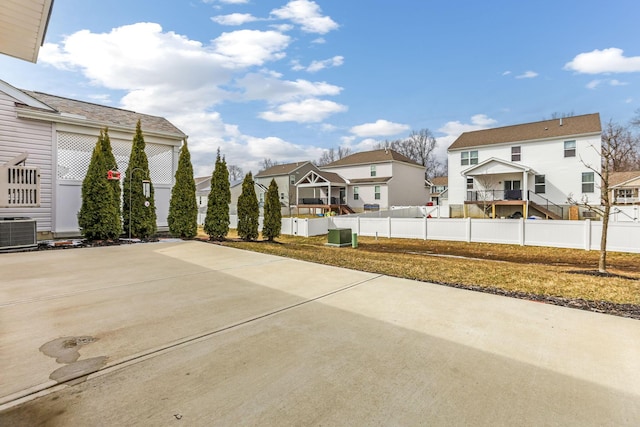 view of patio featuring a residential view, cooling unit, and fence