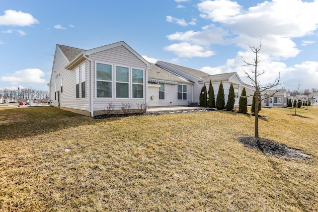 view of front of property featuring a front lawn and a patio