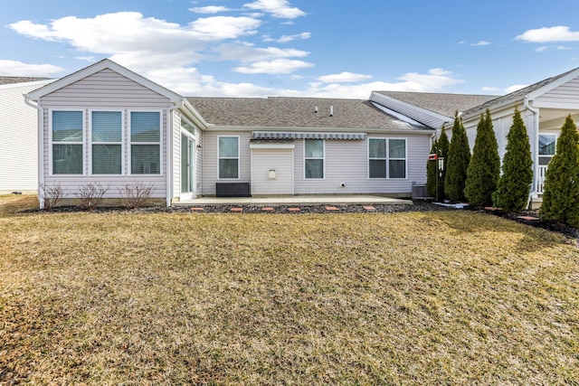 ranch-style home with central AC, a front yard, a patio, and roof with shingles