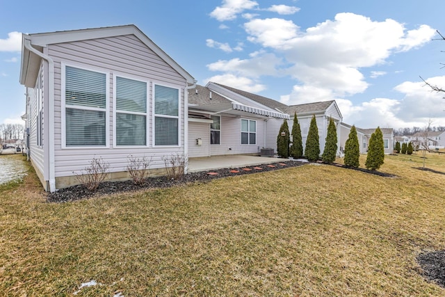 back of house featuring a yard, central AC, and a patio area