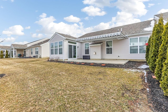 back of house featuring a patio and a lawn