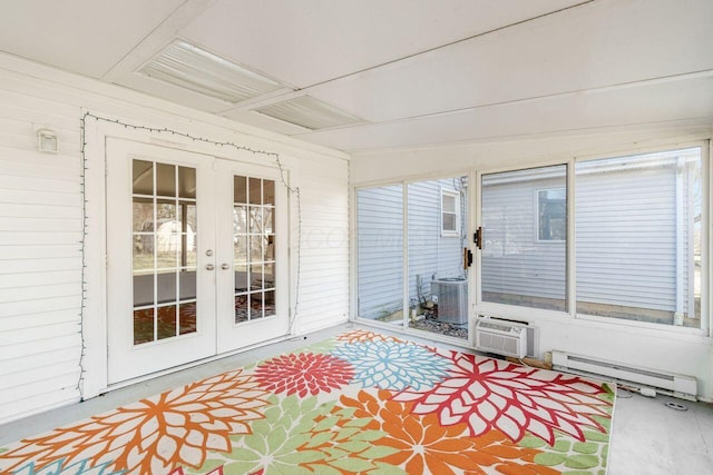 unfurnished sunroom featuring a wall mounted air conditioner, french doors, and baseboard heating