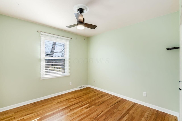 unfurnished room featuring visible vents, a ceiling fan, light wood-type flooring, and baseboards