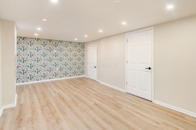 empty room featuring recessed lighting, wood finished floors, and baseboards