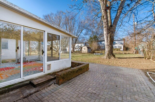 view of patio / terrace featuring a sunroom