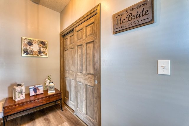 interior space featuring wood finished floors and a textured ceiling