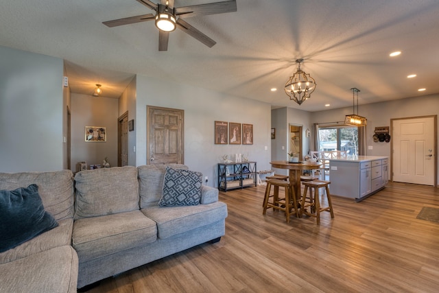 living area with recessed lighting, ceiling fan, and wood finished floors