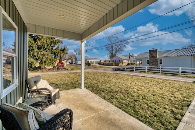 view of patio / terrace with fence and a residential view