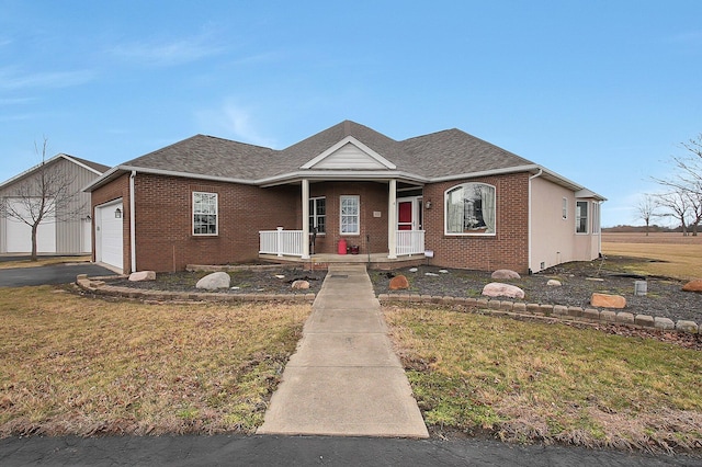 view of front of home featuring a shingled roof, covered porch, brick siding, and an attached garage