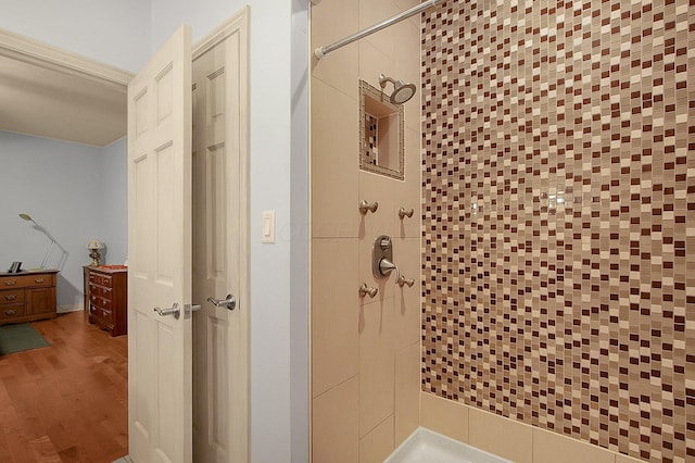 full bathroom with a stall shower and wood finished floors