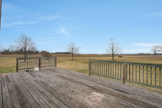 deck featuring a yard and a rural view