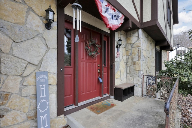 entrance to property featuring stone siding