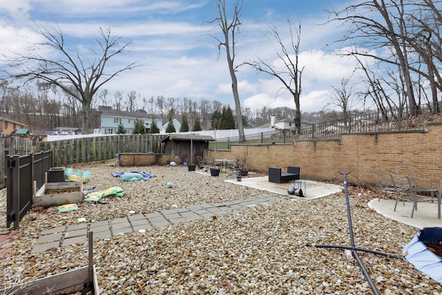 view of yard featuring a patio area, a garden, and a fenced backyard