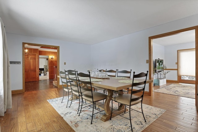 dining room with hardwood / wood-style flooring and baseboards