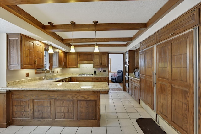 kitchen with light stone counters, beam ceiling, light tile patterned flooring, a sink, and a peninsula