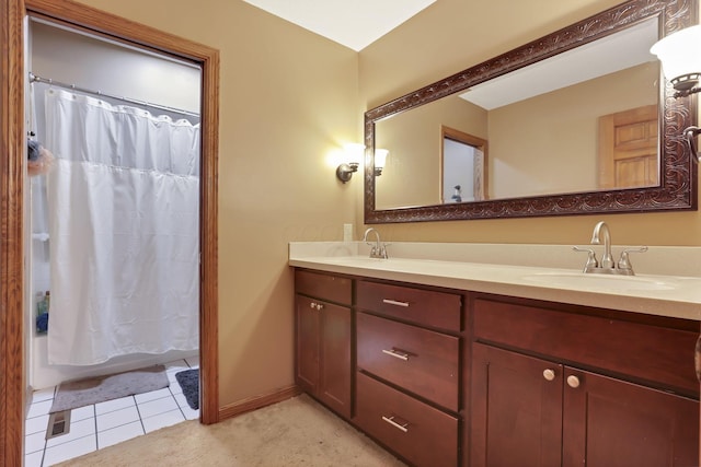 full bathroom with double vanity, shower / bath combo, a sink, and tile patterned floors