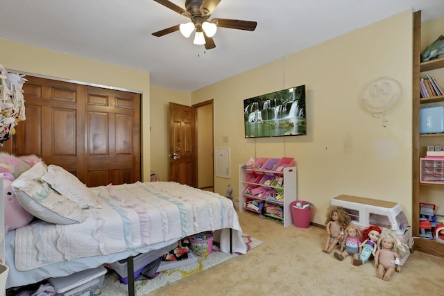 carpeted bedroom with ceiling fan and a closet