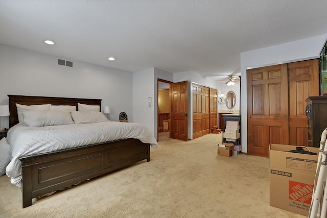 bedroom with light carpet, visible vents, and recessed lighting